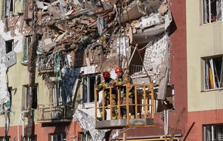 Rescuers work at a site an apartment building hit by a Russian drone strike in Odesa